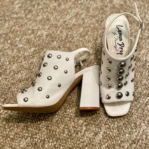 Barely worn white heel with studding details; 3”